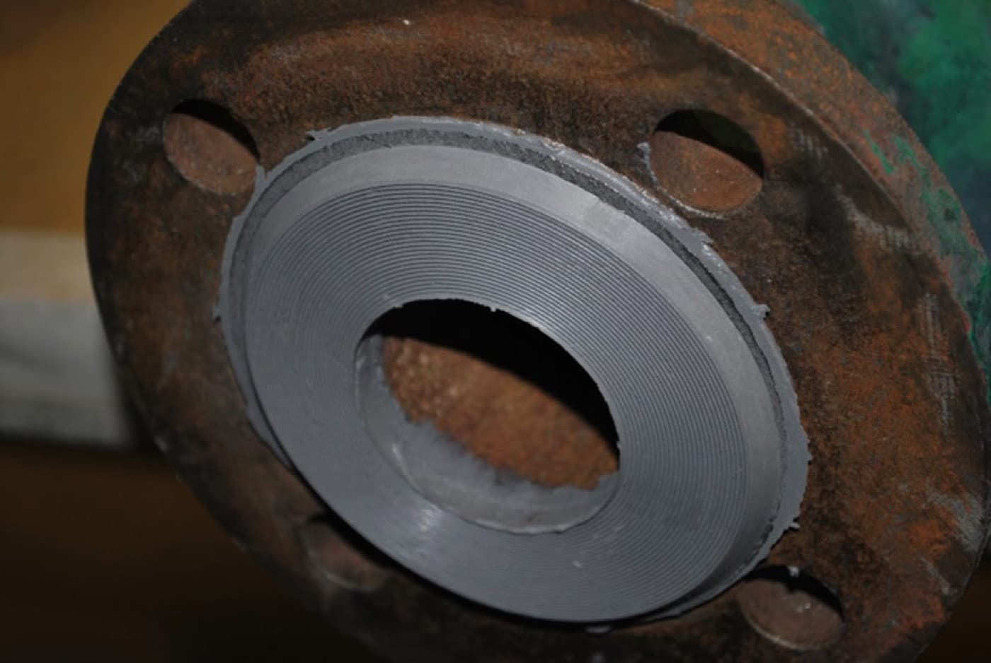 Corroded wellhead flange face prepared and reformed to a flat sealing profile by CM Solutions US