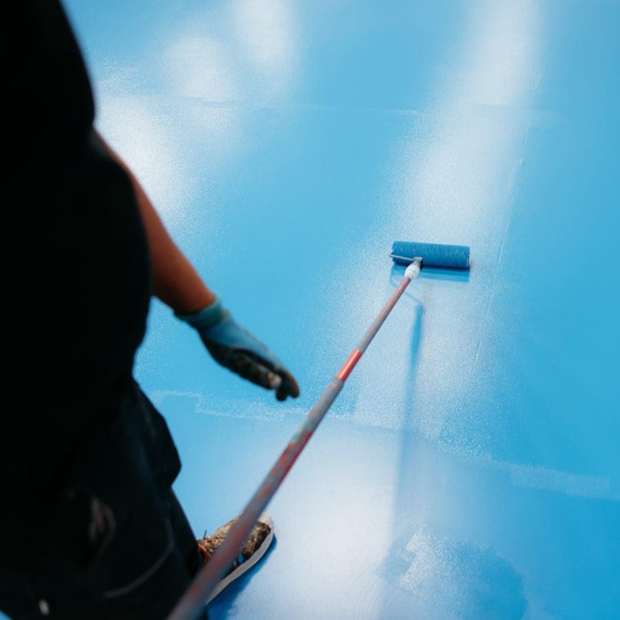 A factory-trained applicator performing protective coating work